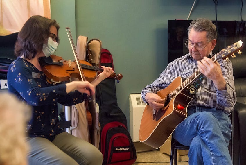 Resident Jack Ellis is pictured as he adds his talents on guitar to Glen Haven Manor’s recently produced Music Therapy video while Music Therapist Heather Leeder, who lead the production, plays the fiddle. JON VISSER PHOTO