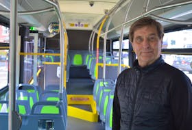 T3 Transit owner Mike Cassidy stands inside one of the eight new buses that entered service on Thursday in Charlottetown, Stratford and Cornwall.