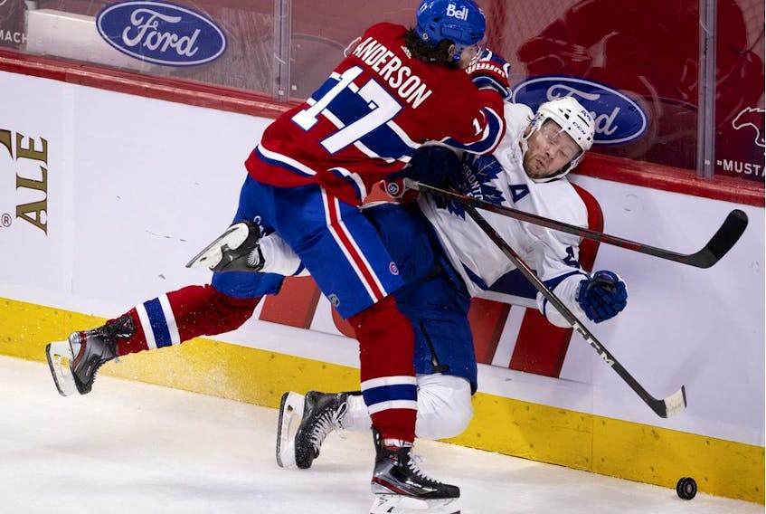Canadiens' Josh Anderson drives Leafs defenceman Morgan Rielly into the boards Wednesday night. Anderson, who was acquired via trade during the off-season, has brought much-needed size and toughness to Montreal's lineup.