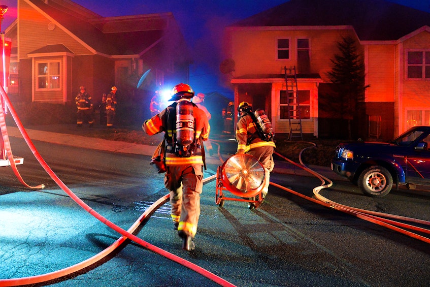 Firefighters battle a house fire on Hamlyn Road in St. John's Friday night. Keith Gosse/The Telegram