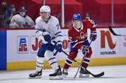  Maple Leafs’ Adam Brooks and Cole Caufield of the Canadiens watch over the play on Wednesday, April 28, 2021 in Montreal. Minas Panagiotakis/Getty Images