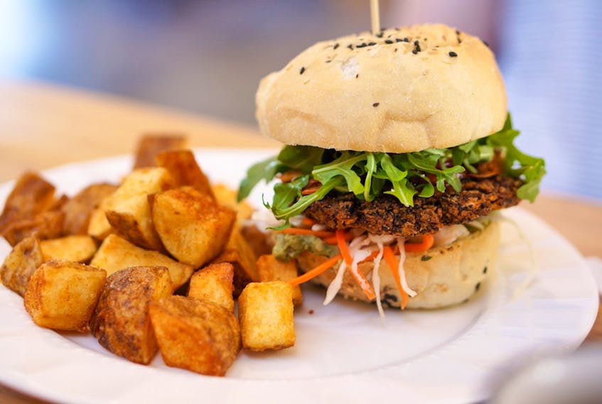 The Veggie Burger with a quinoa and black bean patty and many saucy accoutrements. 