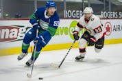  Ottawa Senators defenceman Victor Mete (right) checks Vancouver Canucks forward Bo Horvat n the first period at Rogers Arena, Apr. 22, 2021.
