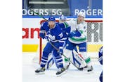 Toronto Maple Leafs T.J. Brodie D (78) defends in front of the net with Vancouver Canucks Brock Boeser LW (6) during the second period in Toronto on Thursday April 29, 2021. Jack Boland/Toronto Sun/Postmedia Network