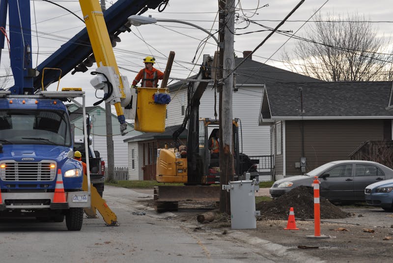 A Newfoundland Power crew works to repair a utility pole on Country Road in Corner Brook that was cracked off when it was hit by a minivan early Friday morning. — Diane Crocker