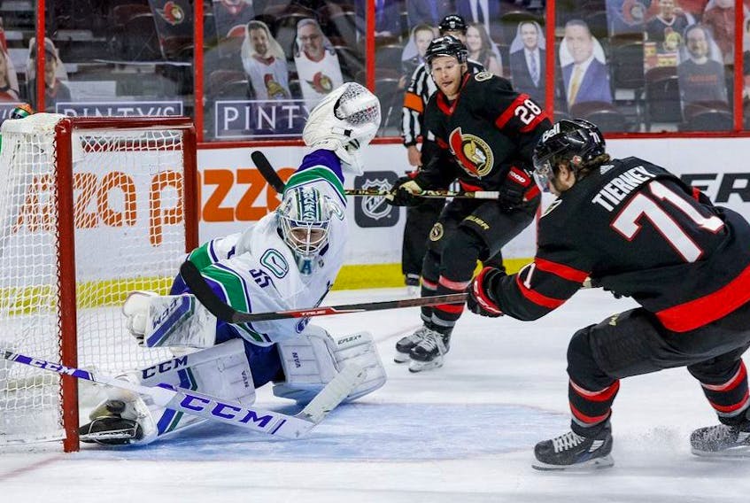  Vancouver Canucks goaltender Thatcher Demko makes a save off of Ottawa Senators centre Chris Tierney (71) as right wing Connor Brown (28) follows the play during the third period.