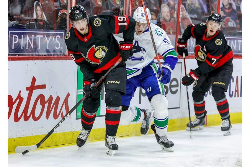  Ottawa Senators right wing Drake Batherson (19) eludes the check of Vancouver Canucks defenceman Tyler Myers (57) as Ottawa Senators left wing Brady Tkachuk (7) follows the play during the third period.