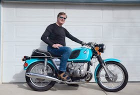 Calgary motorcycle enthusiast Gord McLellan with his finished 1973 BMW R75/5 — a machine he found offered for free on Kijiji. After cautiously adding several hundred kilometres to the bike since completing the project, he’s confident the machine will carry him anywhere he’d like to tour. Photo courtesy of Gord and Krista McLellan	