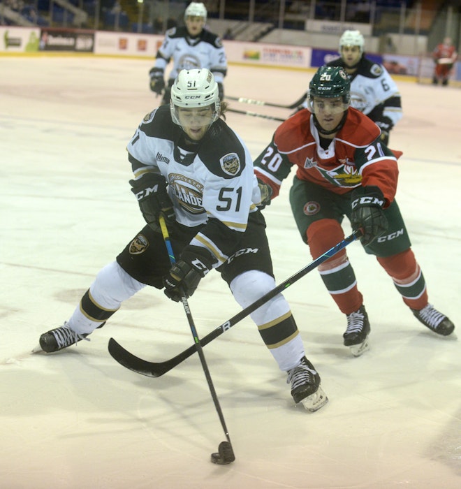 Charlottetown Islanders defenceman Lukas Cormier, left, looks to get away from the pursuit by Halifax Mooseheads captain Justin Barron Sunday at the Eastlink Centre in Charlottetown. - Jason Malloy