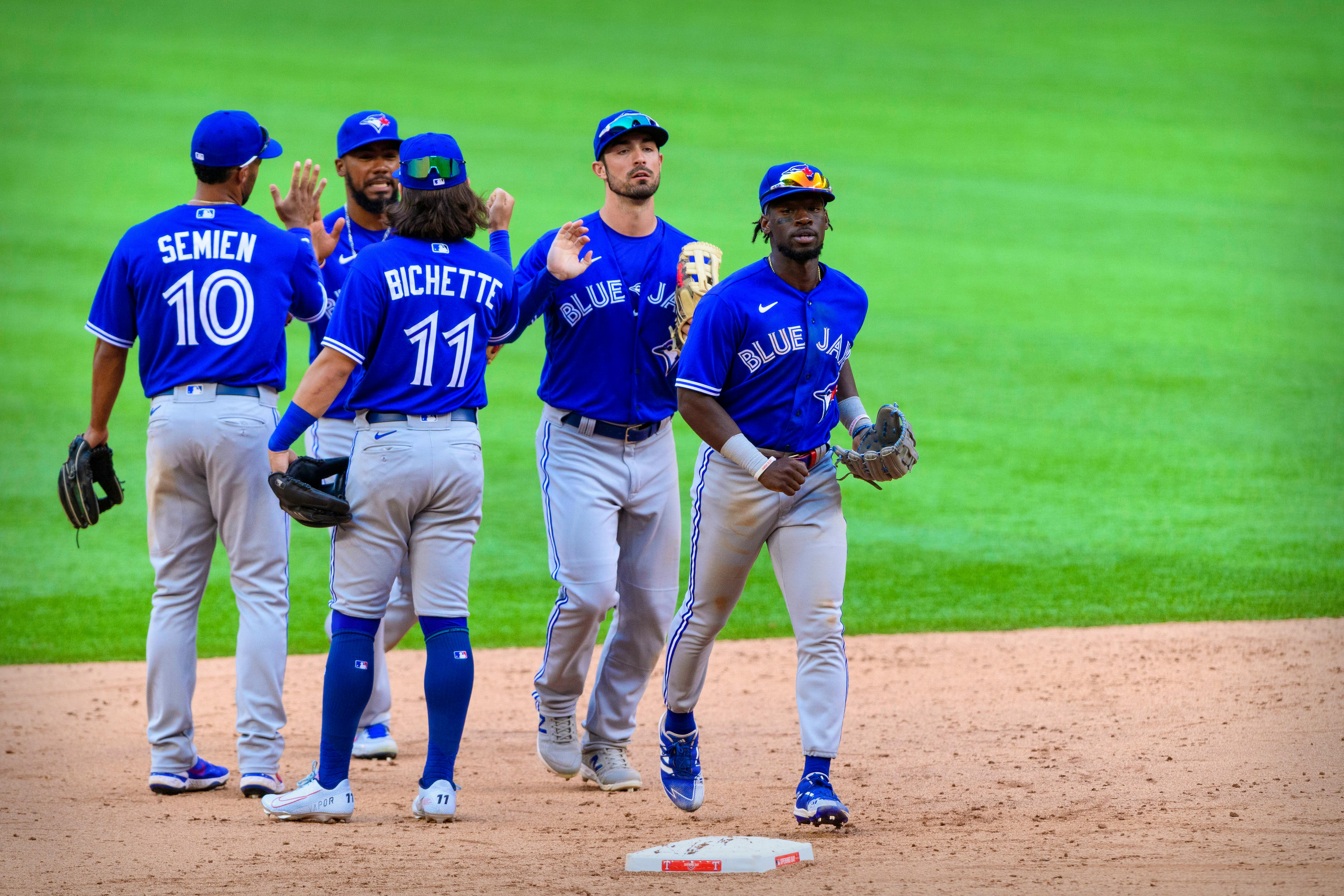 Blue Jays spoil Rangers home opener before largest MLB crowd