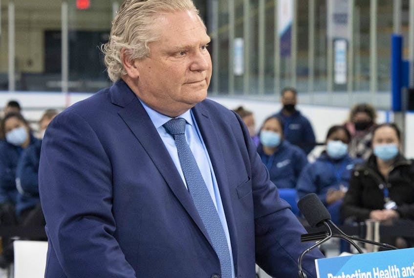 Ontario Premier Doug Ford listens to a question during the daily briefing at a mass vaccination centre in Toronto on Tuesday, March 30, 2021.