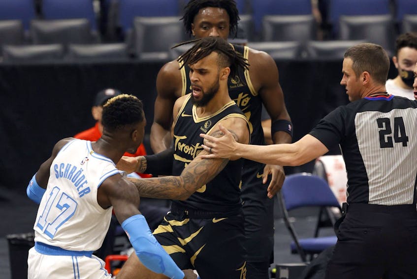 Lakers guard Dennis Schroder (17) and Toronto Raptors guard Gary Trent Jr. (33) push each other as Schroder gets ejected on Tuesday night. 
