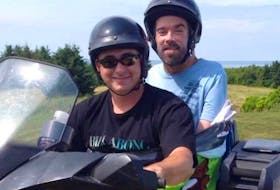 Callum MacQuarrie is seen with his brother-in-law Ken Muise on an all-terrain vehicle in this undated photo. MacQuarrie, who was paralyzed from the neck down after a 1995 diving accident at Inverness beach, rarely left his home without duct tape in case he wanted to go four-wheeling, snowmobiling, or cruising on the water, usually strapped to one of his buddies.