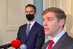 Newly sworn-in Newfoundland and Labrador Premier Andrew Furey is flanked by Justice Minister John Hogan during a media scrum Thursday morning at Government House in St. John's.