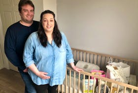 Mom-to-be Jessica Grosset rests her hand on her stomach, standing next to her husband Tyler in the room they're renovating into their baby's room. Now four months pregnant, the Grossets needed in vitro fertilization to conceive. NICOLE SULLIVAN/CAPE BRETON POST 