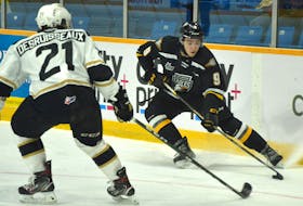Jérémy Langlois of the Cape Breton Eagles, right, looks to make a play as he’s watched by Cédric Desruisseaux of the Charlottetown Islanders during Quebec Major Junior Hockey League action earlier this season at Centre 200 in Sydney. Charlottetown is the top team in the Maritimes Division, while Cape Breton currently sits in sixth place. JEREMY FRASER • CAPE BRETON POST 