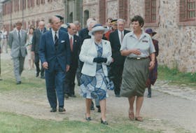 Queen Elizabeth and Prince Philip are given a royal walking tour of the grounds of the Fortress Louisbourg on Aug. 14, 1994, by Parks Canada guide Anne O'Neill. Prince Philip died Friday at the age of 99.