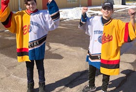 Niall Dingwell, left, and Taylor Bowser split goaltending duties between their hometown Tatamagouche Titans and the Brookfield Elks this season. The netminders were presented with half-and-half jerseys that were cut and stitched back together to include both team’s colours.