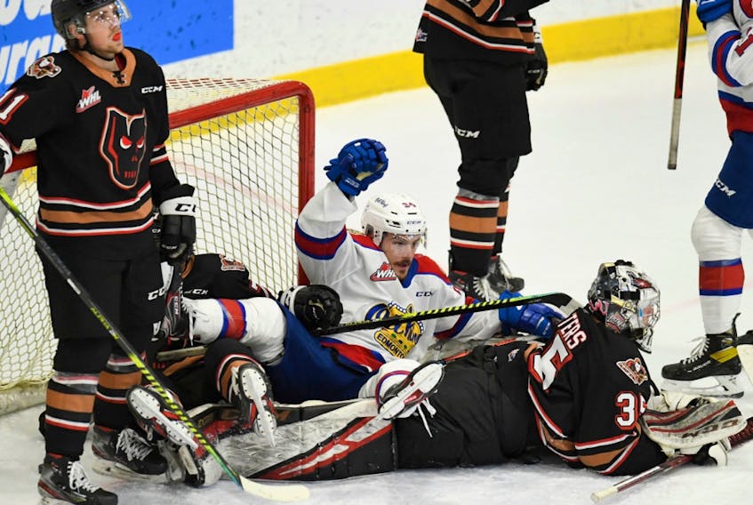 The Edmonton Oil Kings and Calgary Hitmen have a pileup in the crease during  game at Seven Chiefs Sportsplex in Calgary on March 27, 2021.