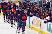 Oilers forward Connor McDavid celebrates his 100th point of the season on a goal by forward Leon Draisaitl against the Vancouver Canucks at Rogers Place in Edmonton Saturday.