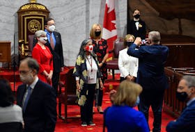 Senators take a photo as they arrive for the opening session in the Senate chamber in Ottawa on Sept. 23, 2020.