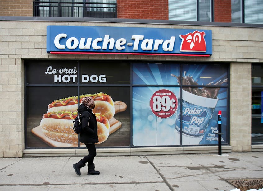 A pedestrian walks past a Couche-Tard convenience store in Montreal, Quebec on Jan. 13, 2021. - Christinne Musch / Reuters