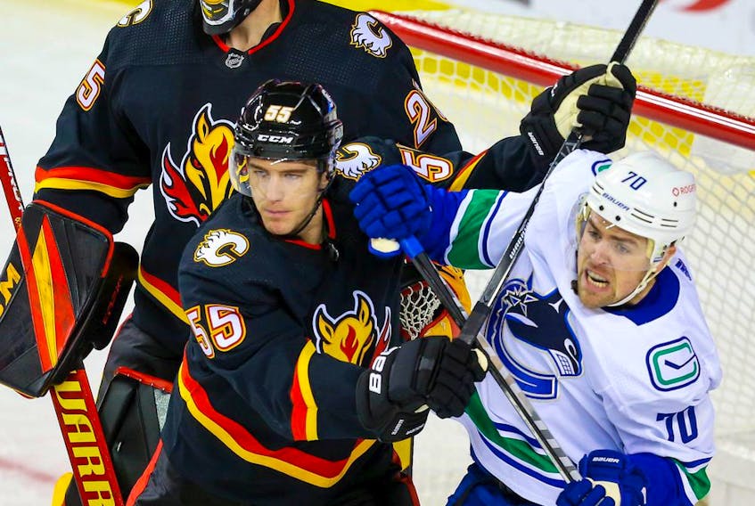 Calgary Flames defenceman Noah Hanifin battles against Tanner Pearson of the Vancouver Canucks during a game earlier this season.