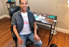 Artist Korey Steckle, 44, sits at the desk in his work room in Glace Bay where he has moved to be closer to his son, whom he says is his biggest inspiration. NICOLE SULLIVAN • CAPE BRETON POST
