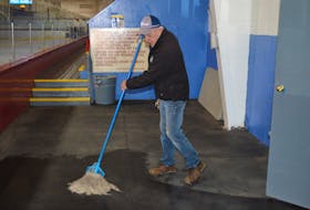 John Harper, assistant ice maker at Simmons Sport Centre, mops the floor at the facility on Tuesday. 
