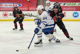 Toronto Maple Leafs centre Auston Matthews moves the puck past Ottawa Senators defenceman Nikita Zaitsev Wednesday in Ottawa as the regular season winds down. 