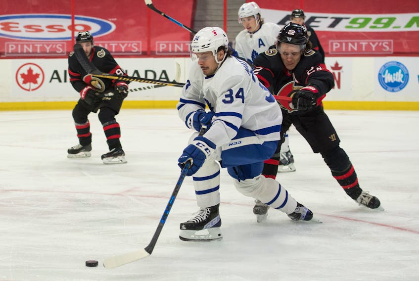 Toronto Maple Leafs centre Auston Matthews moves the puck past Ottawa Senators defenceman Nikita Zaitsev Wednesday in Ottawa as the regular season winds down. 