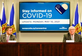 Premier Iain Rankin listens as Dr. Robert Strang, Nova Scotia's chief medical officer of health, speaks at a COVID-10 briefing in Halifax on Monday, May 10, 2021.