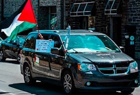 Protesters held signs and the Palestinian flag during the #FreePalestine rally that was held in Halifax on Saturday. Photo Credit: Mohammed Al-Karmanji