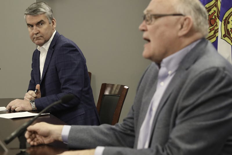 Former Nova Scotia premier Stephen McNeil and Dr. Robert Strang, chief medical officer of health, are shown at a COVID-19 briefing. McNeil committed to closely monitoring the interprovincial boundary but up until a few weeks ago gun-carrying officers were there only for show, a government worker said. - Communications Nova Scotia