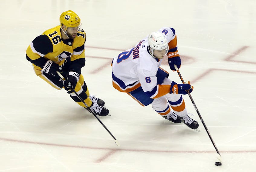 New York Islanders defenceman Noah Dobson, a Summerside native, moves the puck ahead of Pittsburgh Penguins left-winger Jason Zucker in overtime of Game 1 of their playoffs series. 
