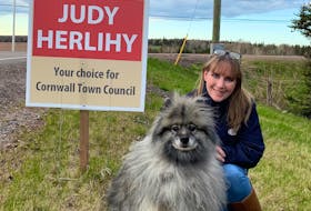 Judy Herlihy poses near one of her campaign signs in Cornwall with her dog. She won the town's recent byelection with 232 votes.