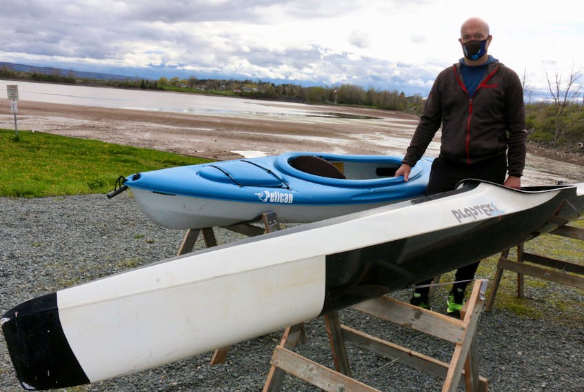 Sheldon Hope, the vice-commodore of the Pisiquid Canoe Club, provides a comparison between a recreational kayak, pictured on the left, and a sprint kayak, the type of light-weight vessel used by club athletes.