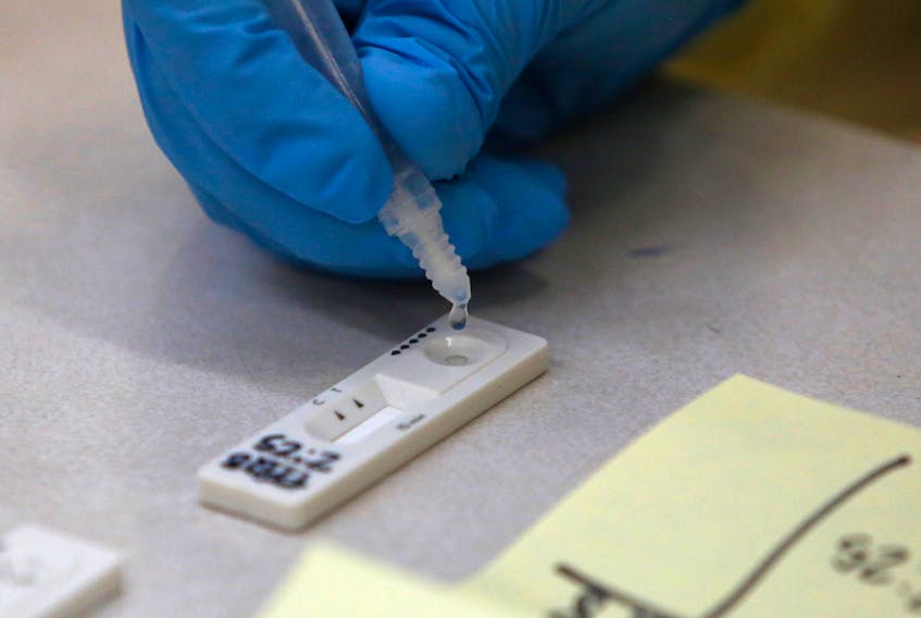 A sample from a patient's swab test, drops on a test strip at a rapid testing site at Central Spryfield School in Halifax Tuesday May 18, 2021.