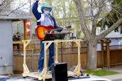 Matt Masters, founder of Curbside Concerts performs on top of his van during a Birthday Party in Calgary on Saturday, May 9, 2020. Darren Makowichuk/Postmedia