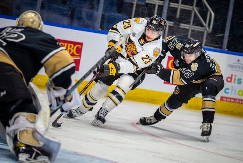 Victoriaville Tigres forward Shawn Element, centre, breaks to the net while being defended by Charlottetown Islanders defenceman Sean Stewart Wednesday in Game 2 of the Quebec Major Junior Hockey League semifinal in Quebec City. - Jonathan Roy
