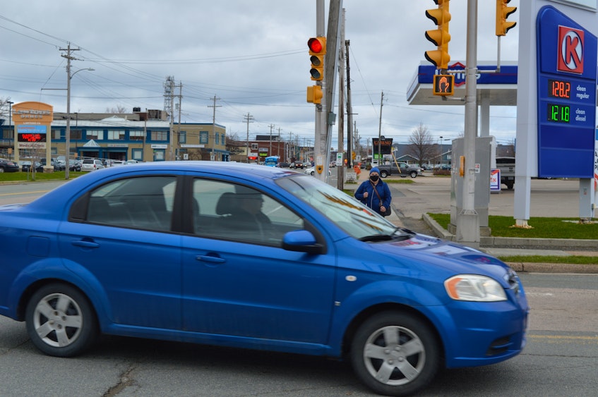 Louise Gillis, who is blind, waits to cross a busy intersection in Sydney. Chris Connors • Cape Breton Post - Christopher Connors