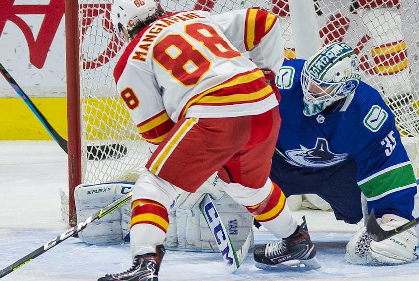  Calgary Flames forward Andrew Mangiapane scores on Vancouver Canucks goalie Thatcher Demko in the third period at Rogers Arena in Vancouver. The Canucks won 4-2.
