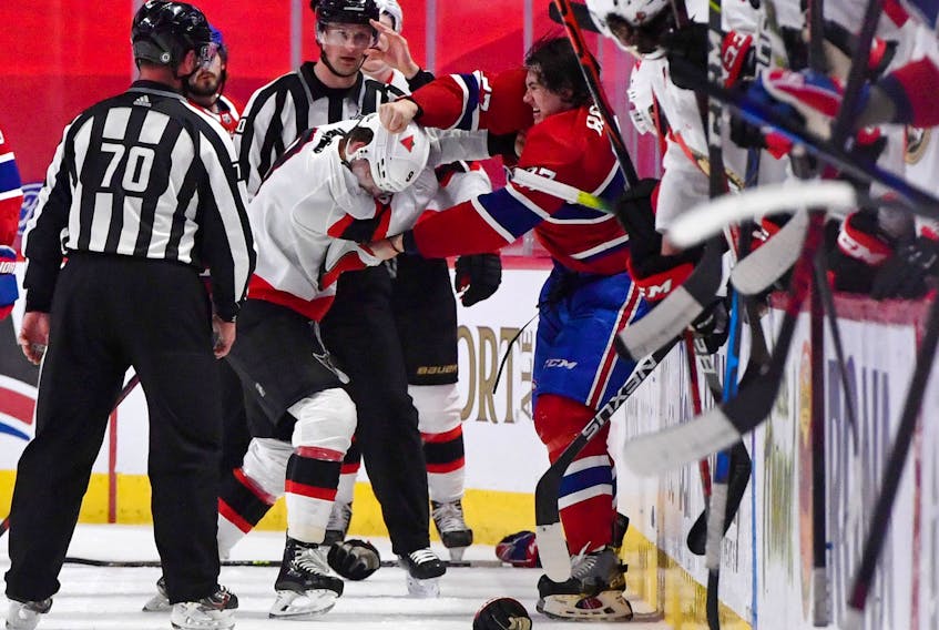 Ottawa Senators forward Josh Norris (9) fights with Montreal Canadiens defenceman Alexander Romanov  during Saturday's game.