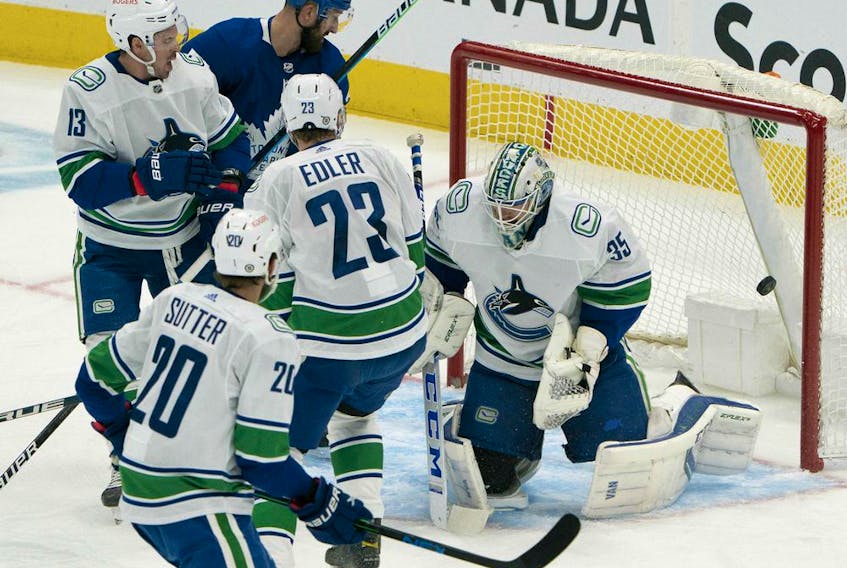 Vancouver Canucks goaltender Thatcher Demko (35) is unable to stop the puck on a shot  by Toronto Maple Leafs center Auston Matthews during the second period at Scotiabank Arena.