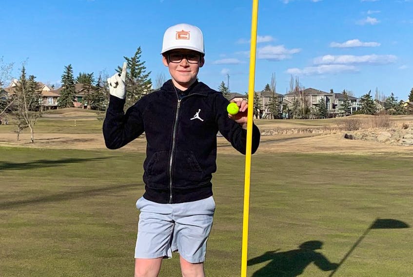 Chestermere's Griffin Maillot, 10, celebrates his hole-in-one on No. 6 at Lakeside Golf Club in April 2021.  (supplied photo)