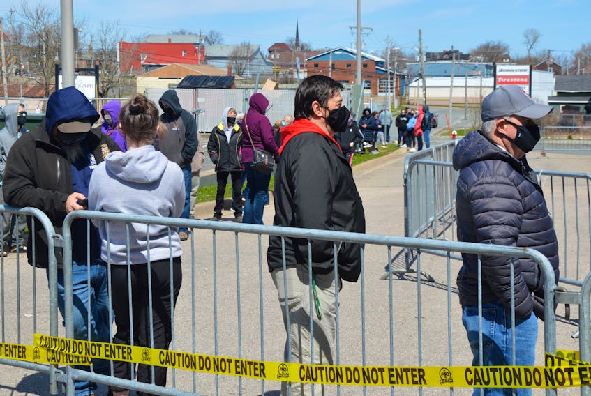 At least 100 people arrive early at Centre 200 to line up for COVID-19 rapid testing — including those who heard about a possible COVID exposure at Riverview High School. IAN NATHANSON/CAPE BRETON POST  