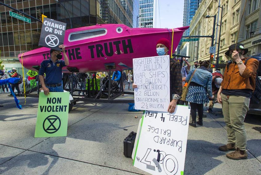  Several dozen supporters of the environmental group Extinction Rebellion occupy the intersection of Granville and Georgia streets in Vancouver, B.C. Saturday, May 1, 2021. The event kicks-off five days of ‘Spring Rebellion’ by the group who are calling for changes to society’s attitudes toward the environment.