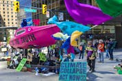  Several dozen supporters of the environmental group Extinction Rebellion occupy the intersection of Granville and Georgia streets in Vancouver, B.C. Saturday, May 1, 2021.