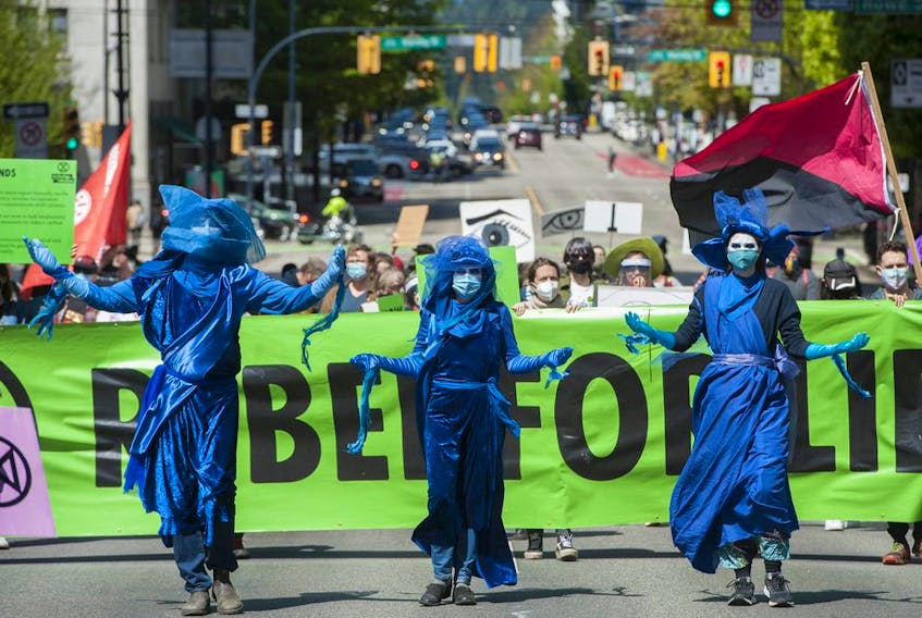 Several dozen supporters of the environmental group Extinction Rebellion occupy the intersection of Granville and Georgia Streets in Vancouver, B.C. Saturday, May 1, 2021. The event kicks-off five days of 'Spring Rebellion' by the group who are calling for changes to society's attitudes toward the environment.