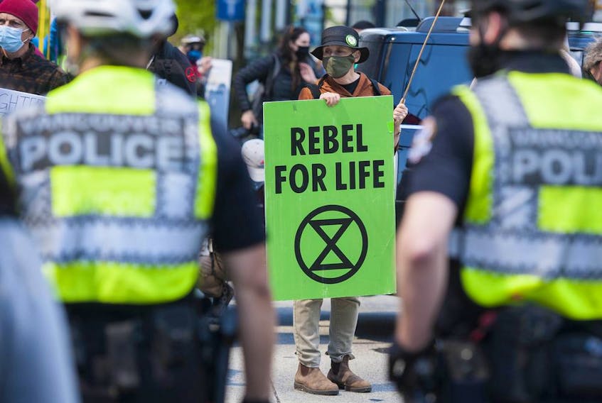  Several dozen supporters of the environmental group Extinction Rebellion occupy the intersection of Granville and Georgia Streets in Vancouver, B.C. Saturday, May 1, 2021.
